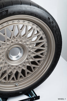 Close-up of a single white gold HRE 501 Classic 2-piece centerlock wheel on a white background.